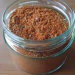 Mason jar on counter full of taco seasoning.