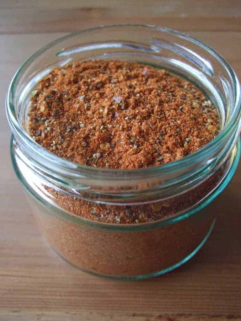 Mason jar on counter full of taco seasoning.