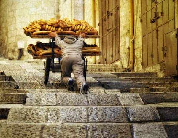 man pushing bread cart up steps - common paleo diet struggles
