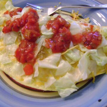 Enchilada omelet on a plate.
