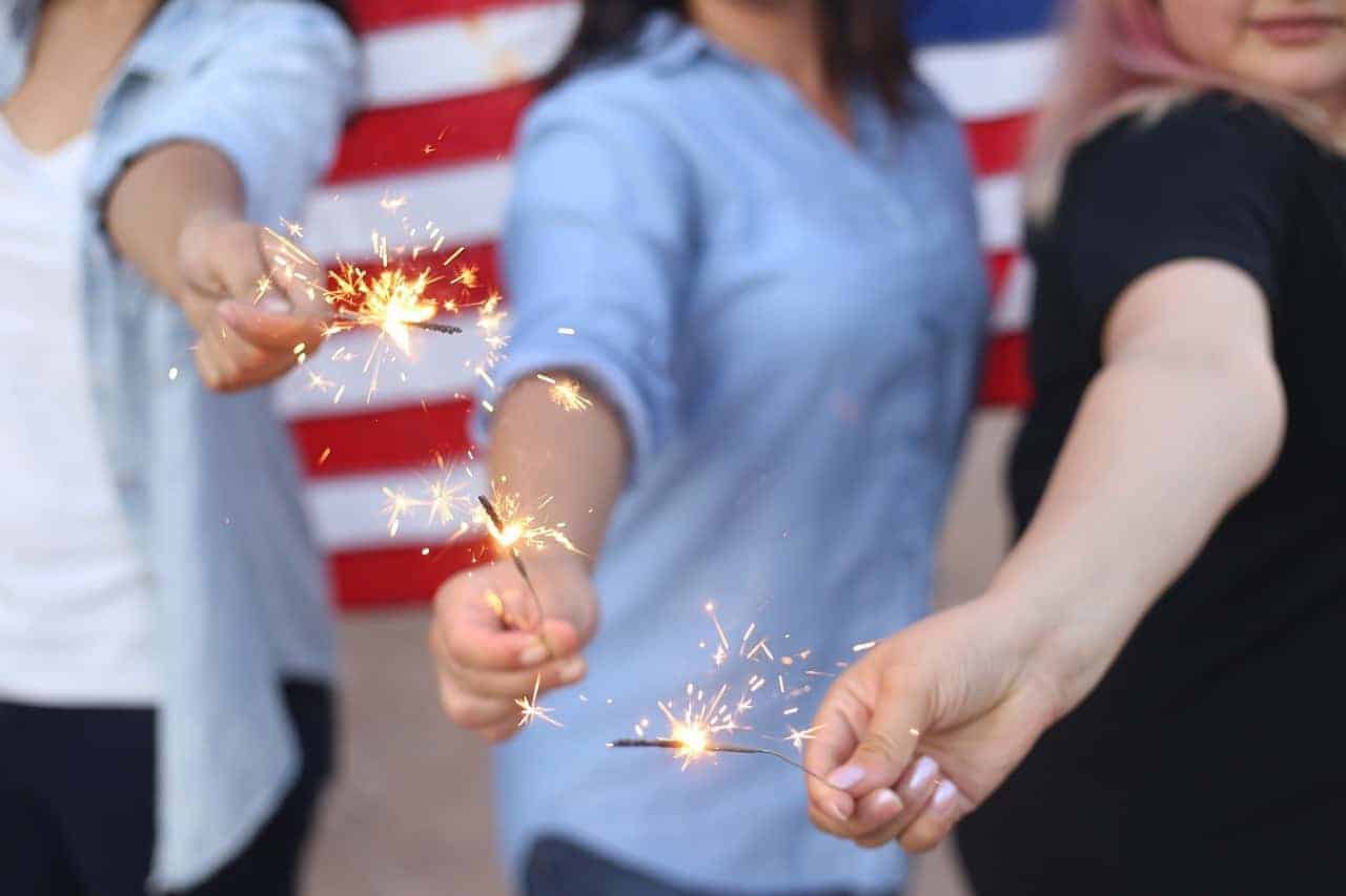 fourth of july keto recipes - three women holding sparklers in front of american flag