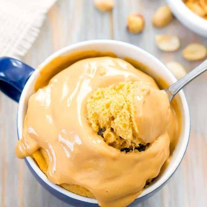 keto peanut butter mug cake with a spoon on table