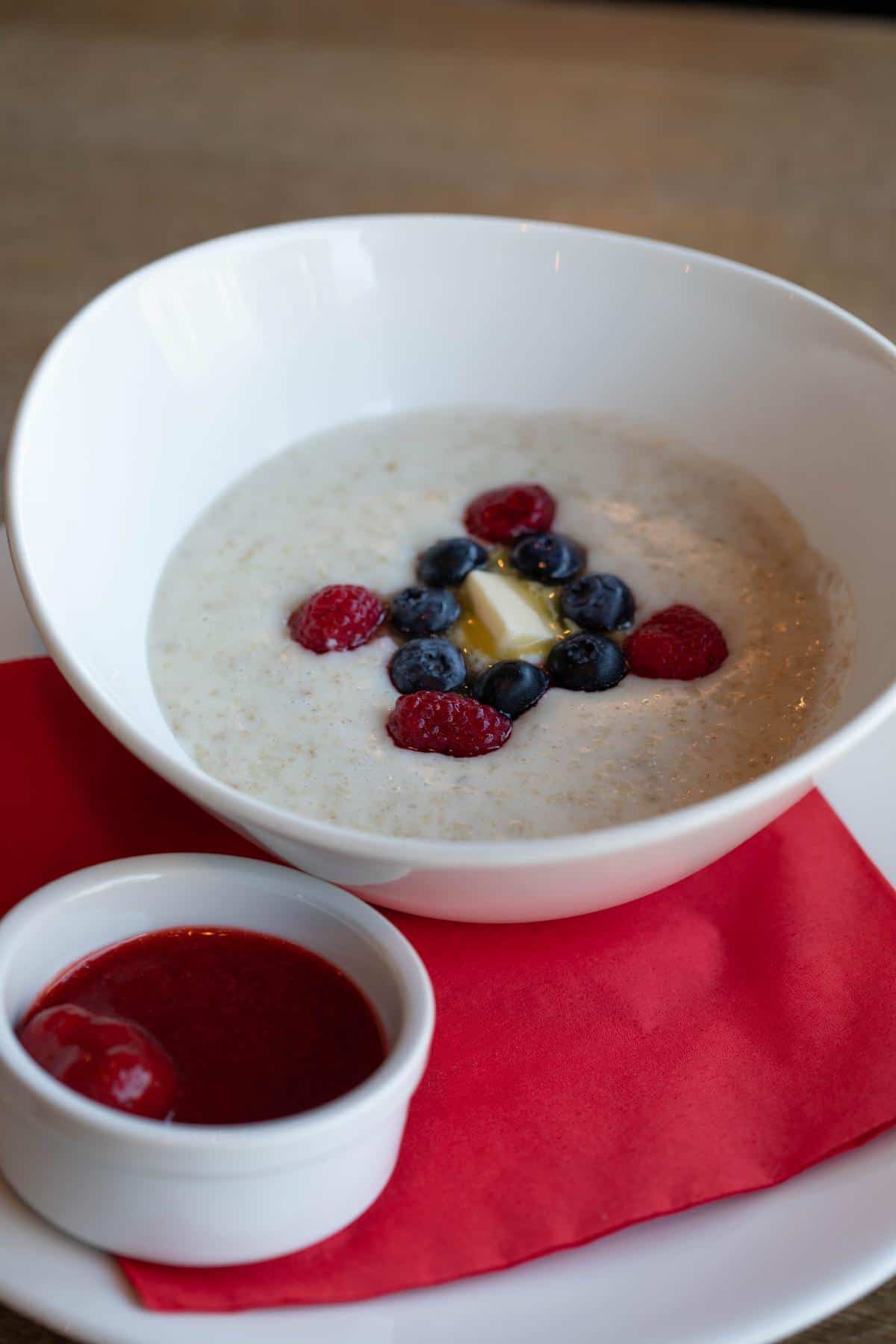 Keto oatmeal with butter and berries on the counter.