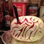 melon brain with a knife in it on a party table