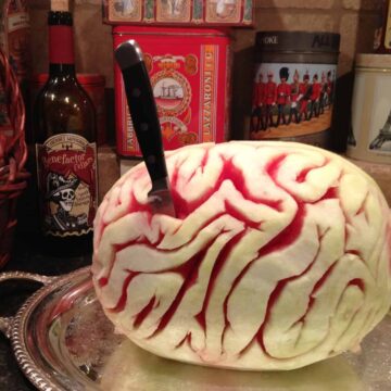 melon brain with a knife in it on a party table