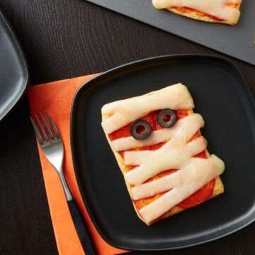 mini mummy pizzas on a plate