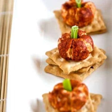 mini pumpkin cheese balls on a platter