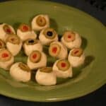 mozzarella eyeballs on a green plate