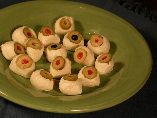mozzarella eyeballs on a green plate