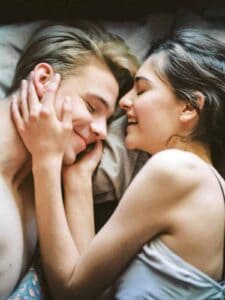 Health Benefits of Sex: Couple Laying in Bed Together