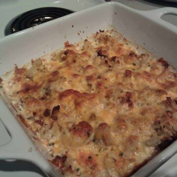 Cheesy Bacon Cauliflower in a white baking dish