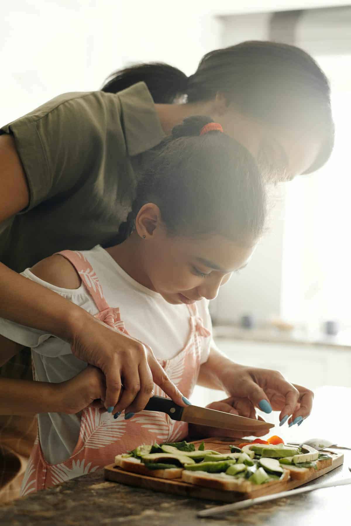 busy mom in the kitchen cooking with her daughter