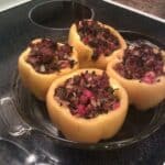 paleo stuffed peppers in a pie plate on stove top