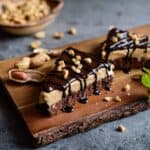 Chocolate Peanut Butter Cream Pie slices on wooden cutting board
