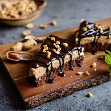 Chocolate Peanut Butter Cream Pie slices on wooden cutting board