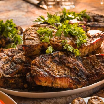 Pile of pork chops on a plate.