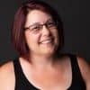 Bright smiling woman with glasses, Heather Cooan portrait.